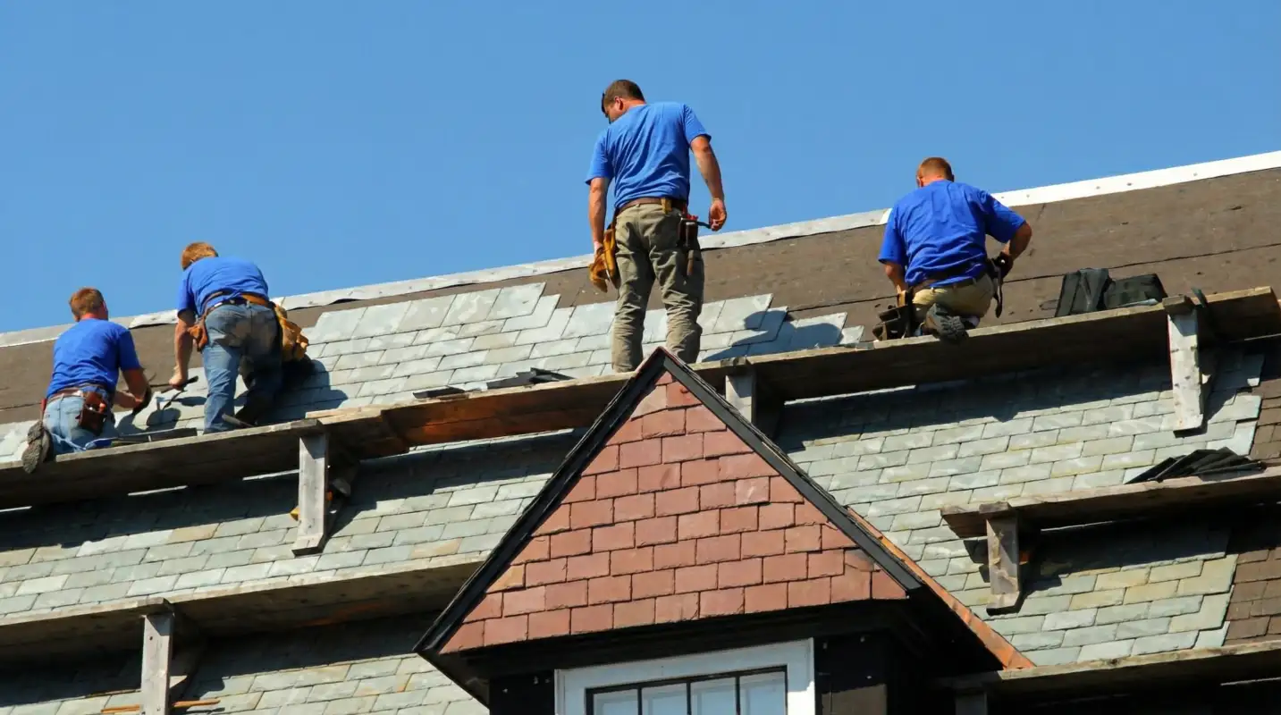Roof replacement in progress with a team of professional contractors installing new shingles on a residential home in Richmond, VA