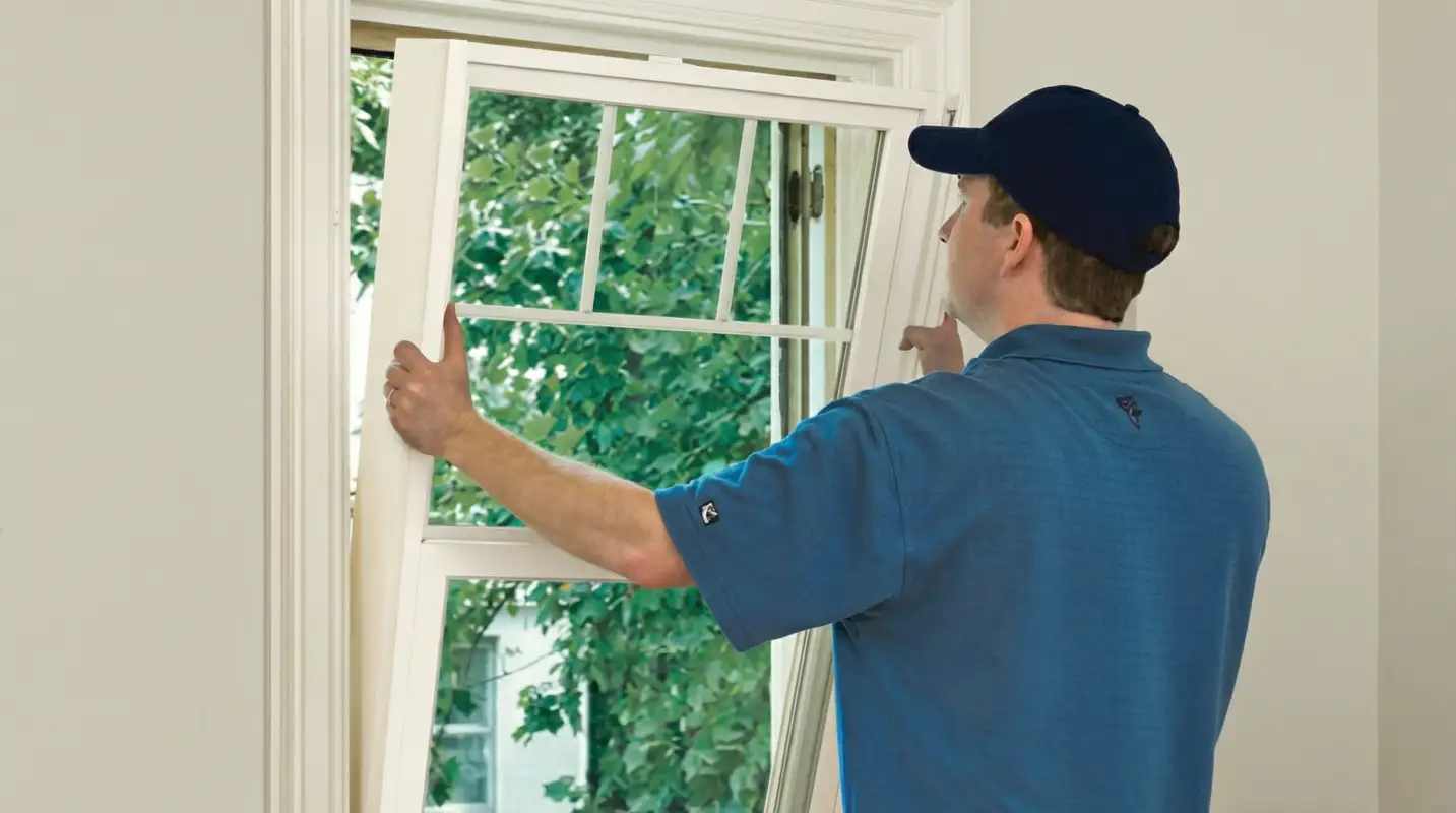 Professional contractors performing a residential window insulation and replacement service in Richmond, VA